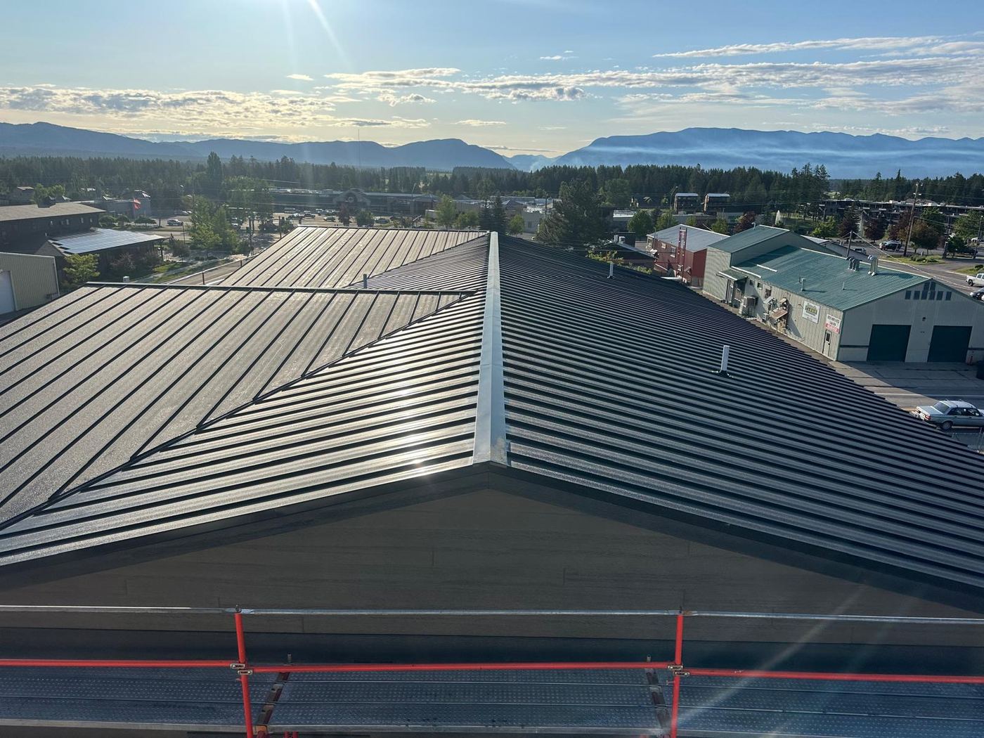 Standing seam metal roof on a commercial building, morning light