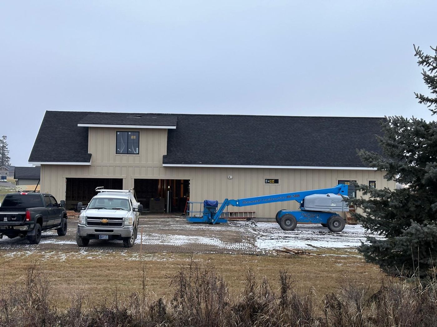 New construction building with a completed shingle roof